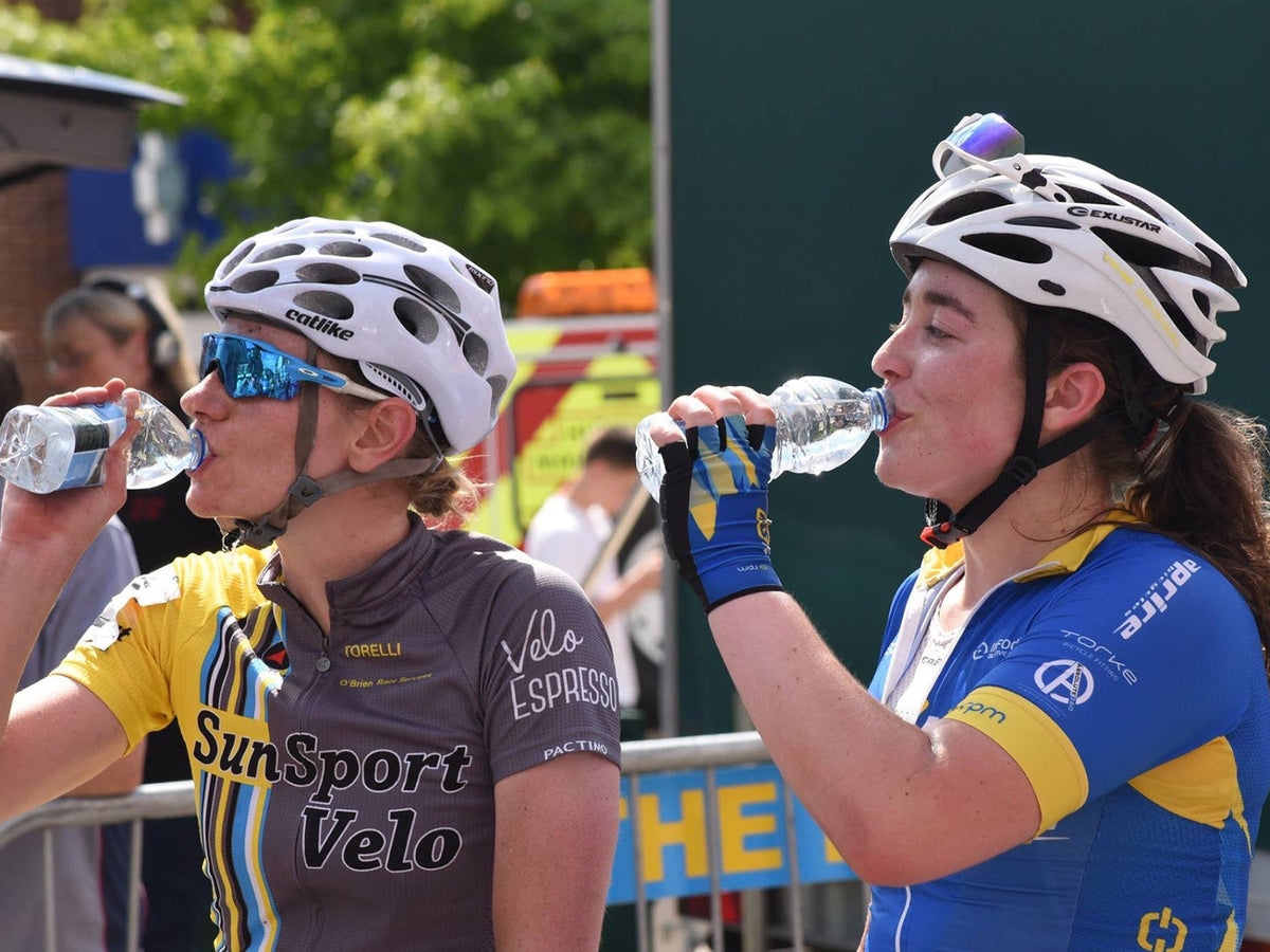 Cyclists hydrating after a ride as part of their post-bike ride recovery