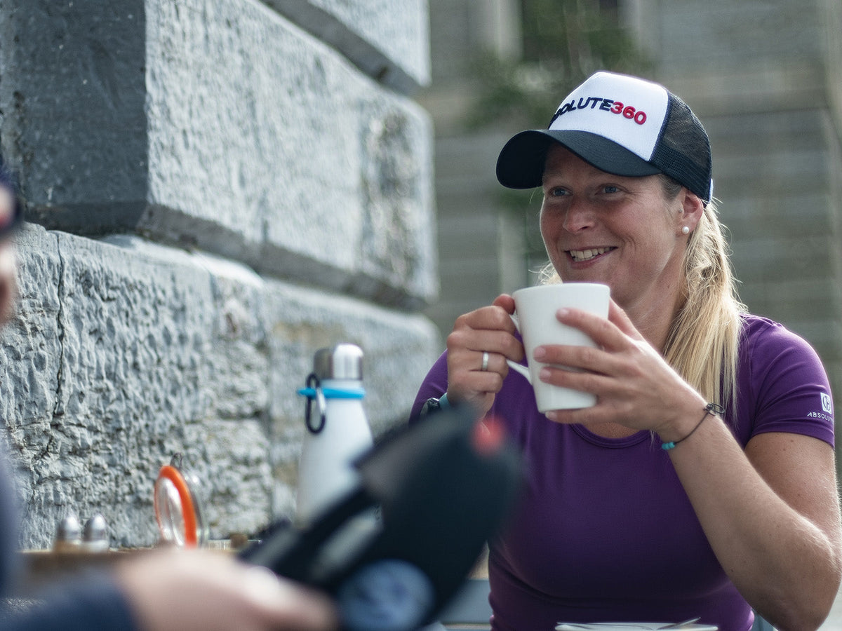 Runner relaxing with a hot drink after exercise as part of a post-workout recovery routine