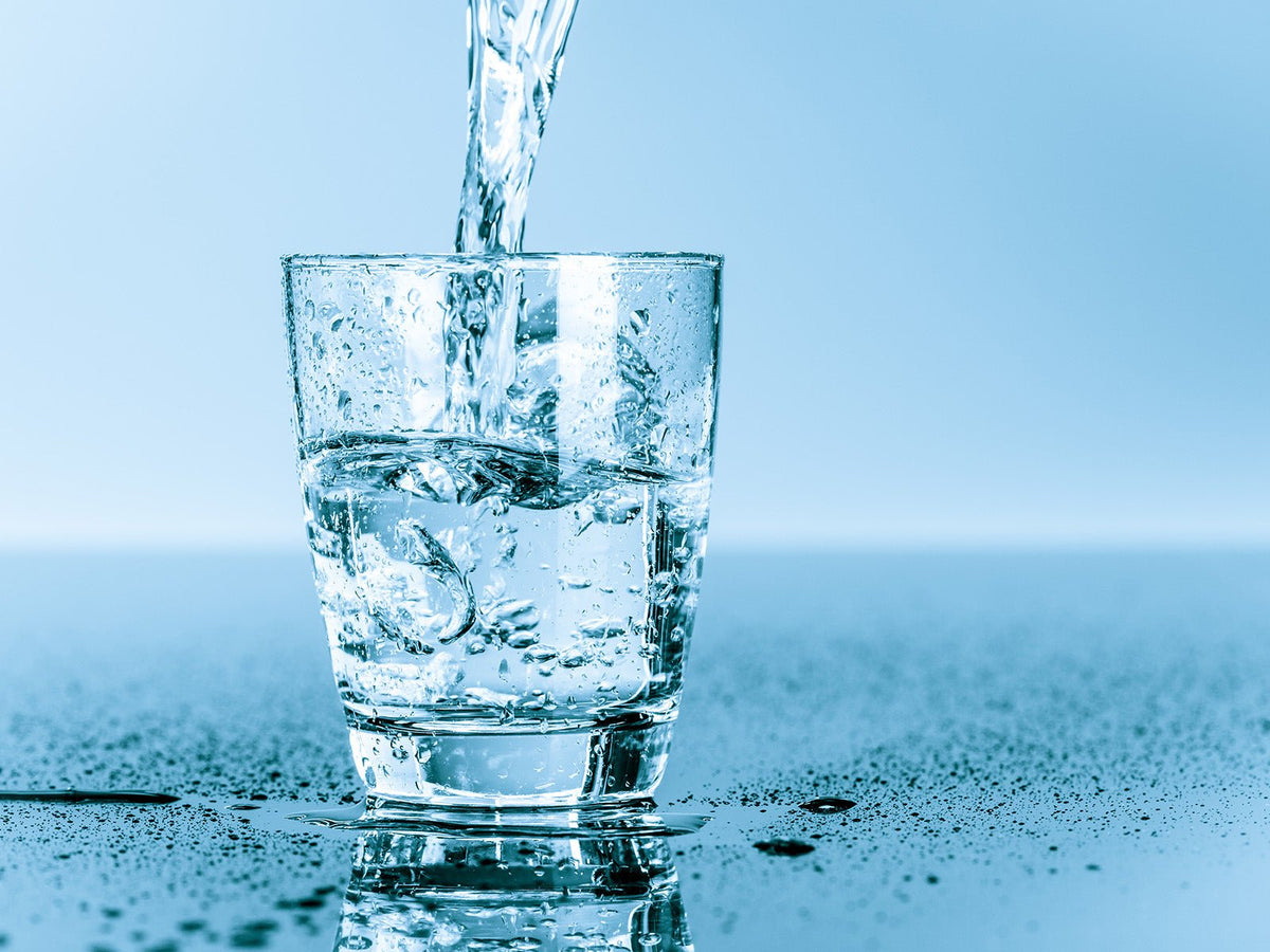 Fresh water being poured into a glass to encourage healthy hydration habits