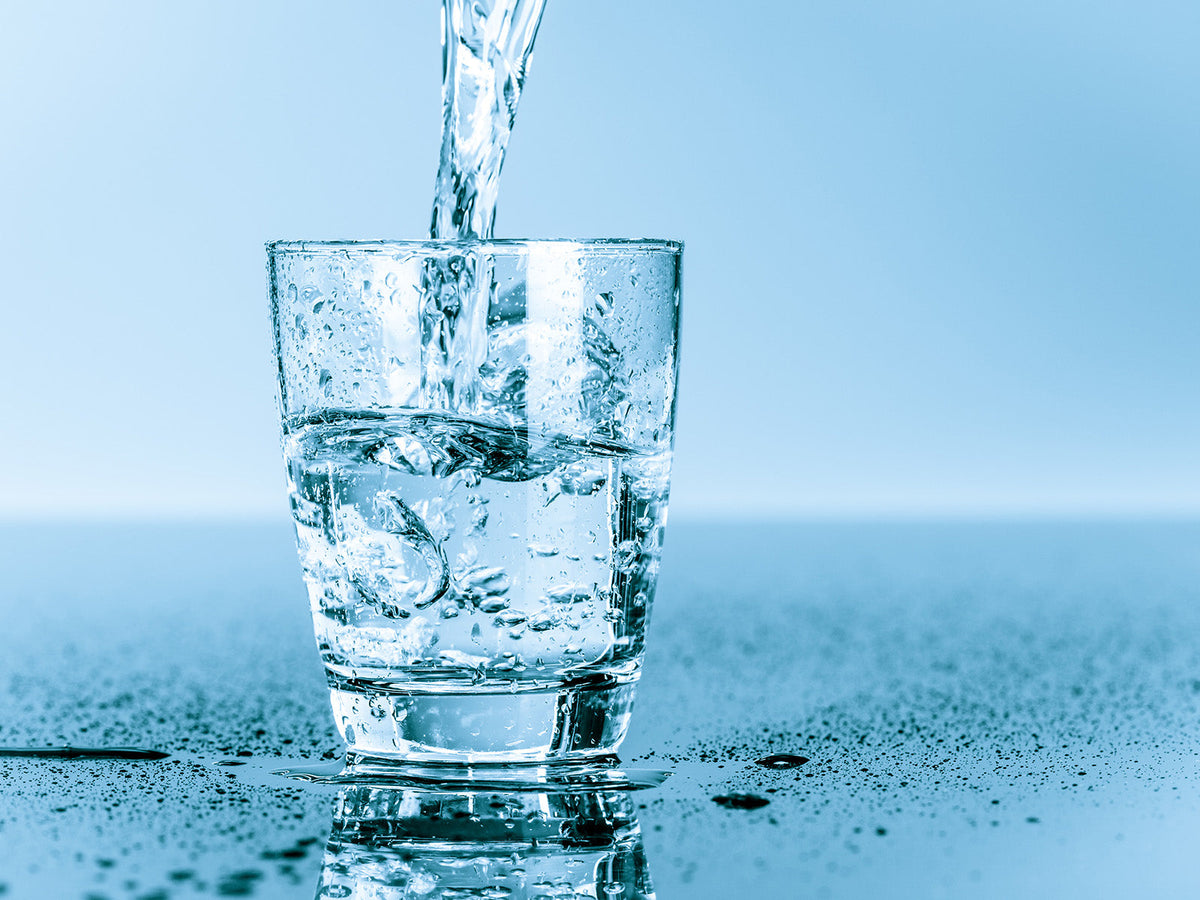 Fresh water being poured into a glass to encourage healthy hydration habits