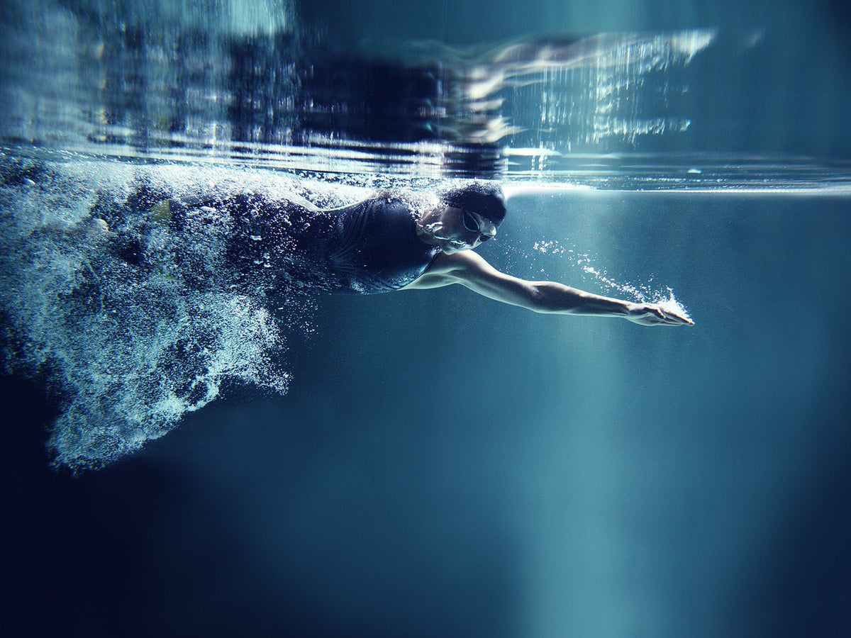 Swimmer underwater performing a freestyle stroke