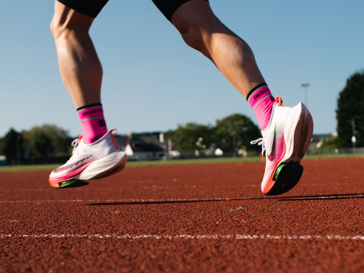 Runner wearing technical running socks on a running track