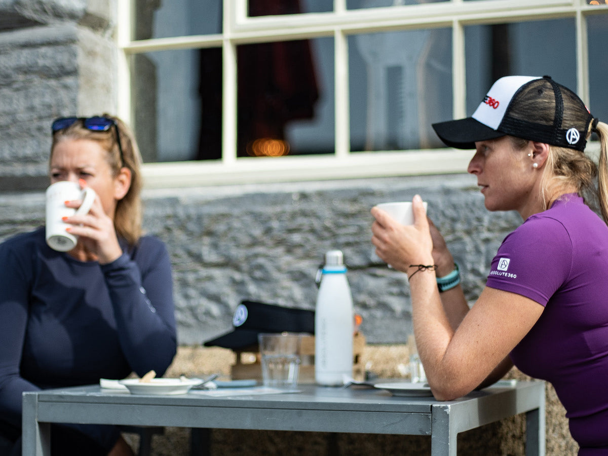 ABSOLUTE360 athletes relaxing with food and drinks as part of their post-workout recovery routine