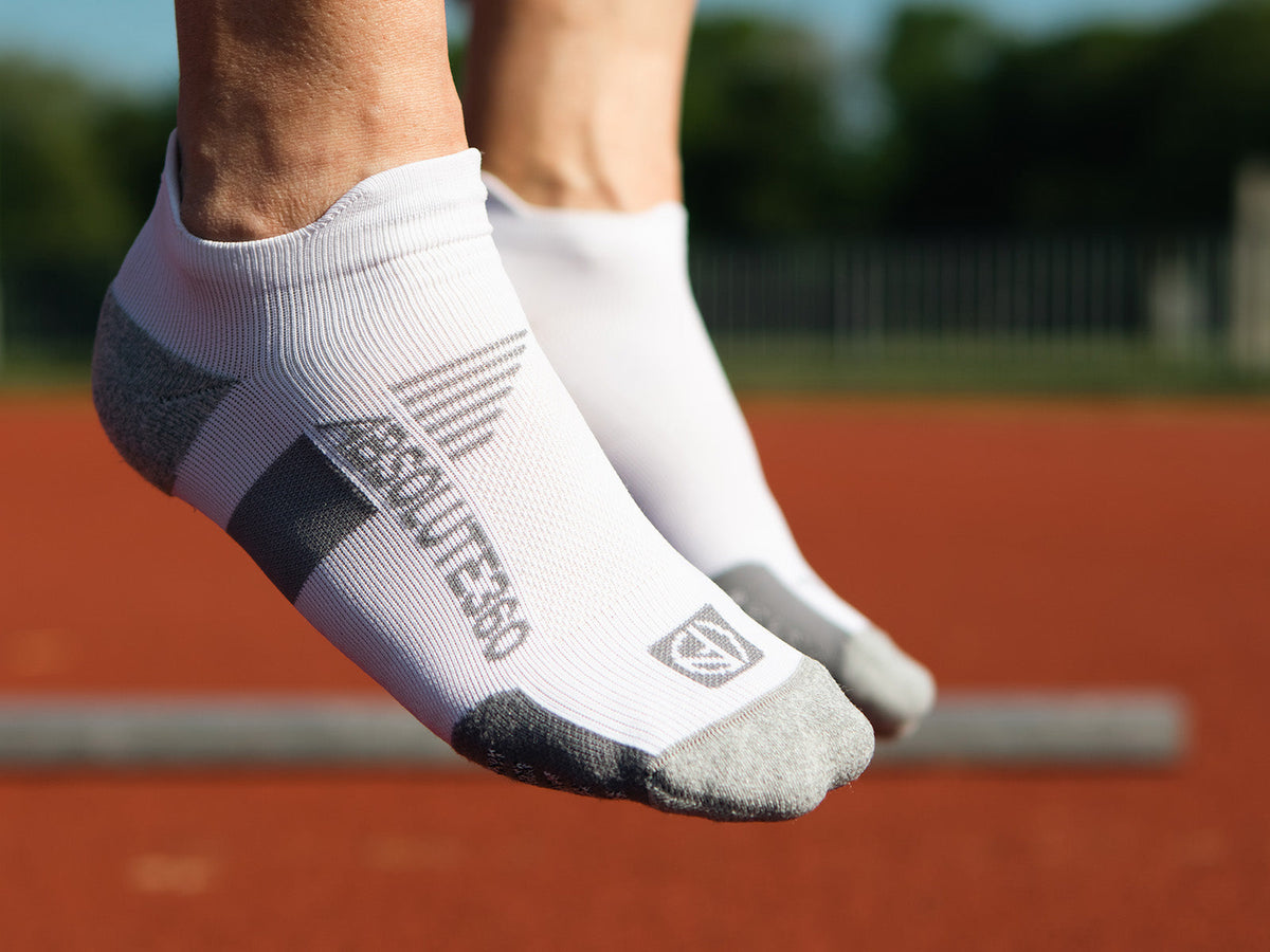 White ABSOLUTE360 Low-Cut Running Socks worn on a running track