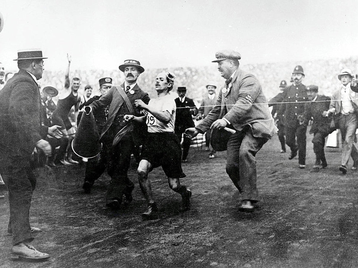 Dorando Pietri helped towards the finish of the 1908 Olympic marathon in London