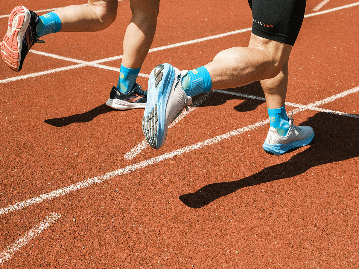 Runners wearing ABSOLUTE360 anti-blister running socks on a running track