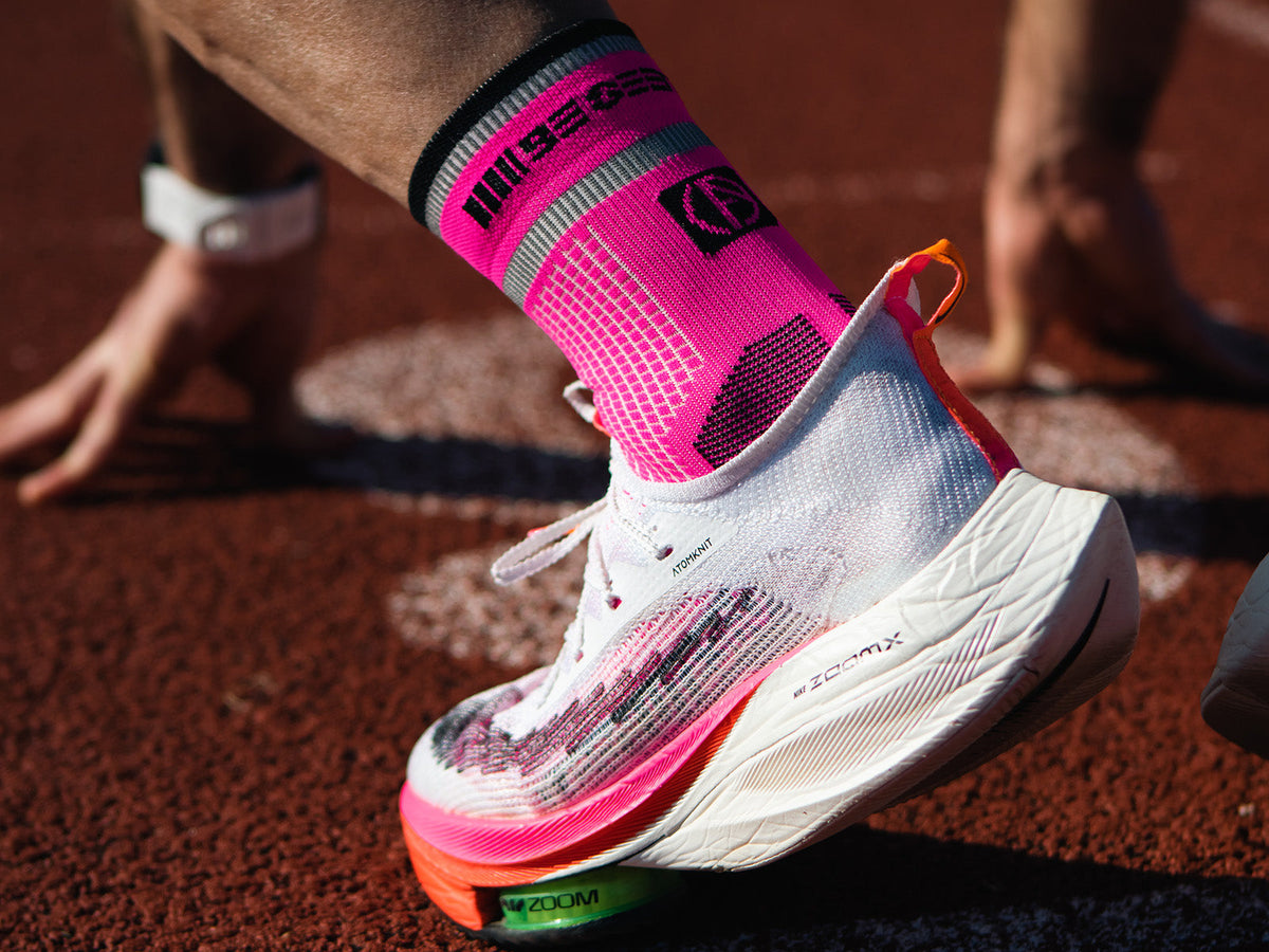 Runner wearing ABSOLUTE360® running socks and running shoes on a track