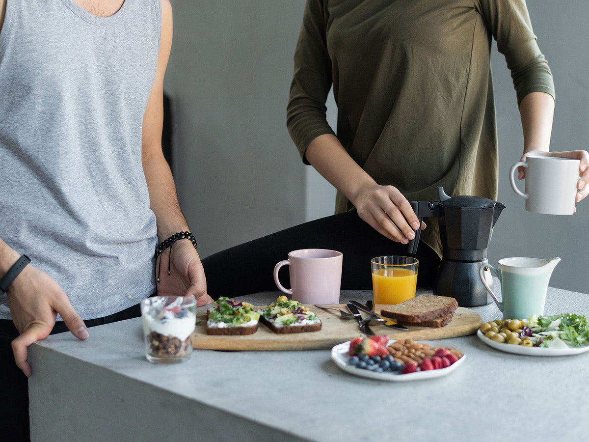 Healthy post-workout breakfast with wholegrain toast, fruit, yoghurt and coffee prepared after exercise