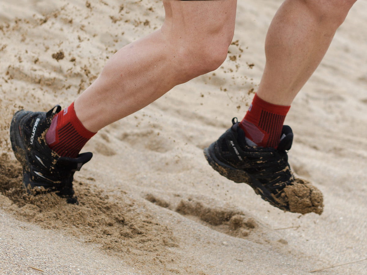 Runner wearing ABSOLUTE360 Performance Running Socks on sandy terrain
