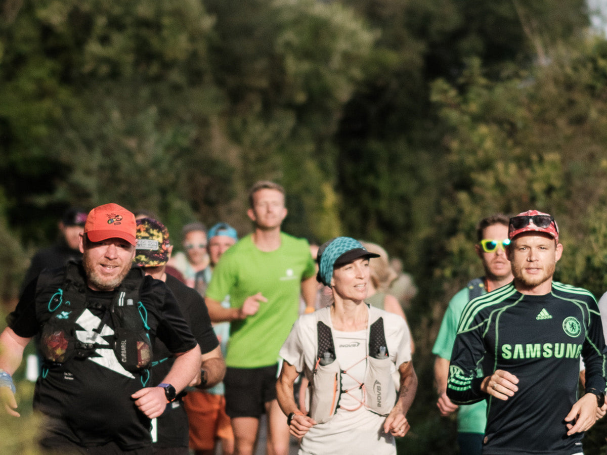 A group of runners enjoying a run together through a wooded setting