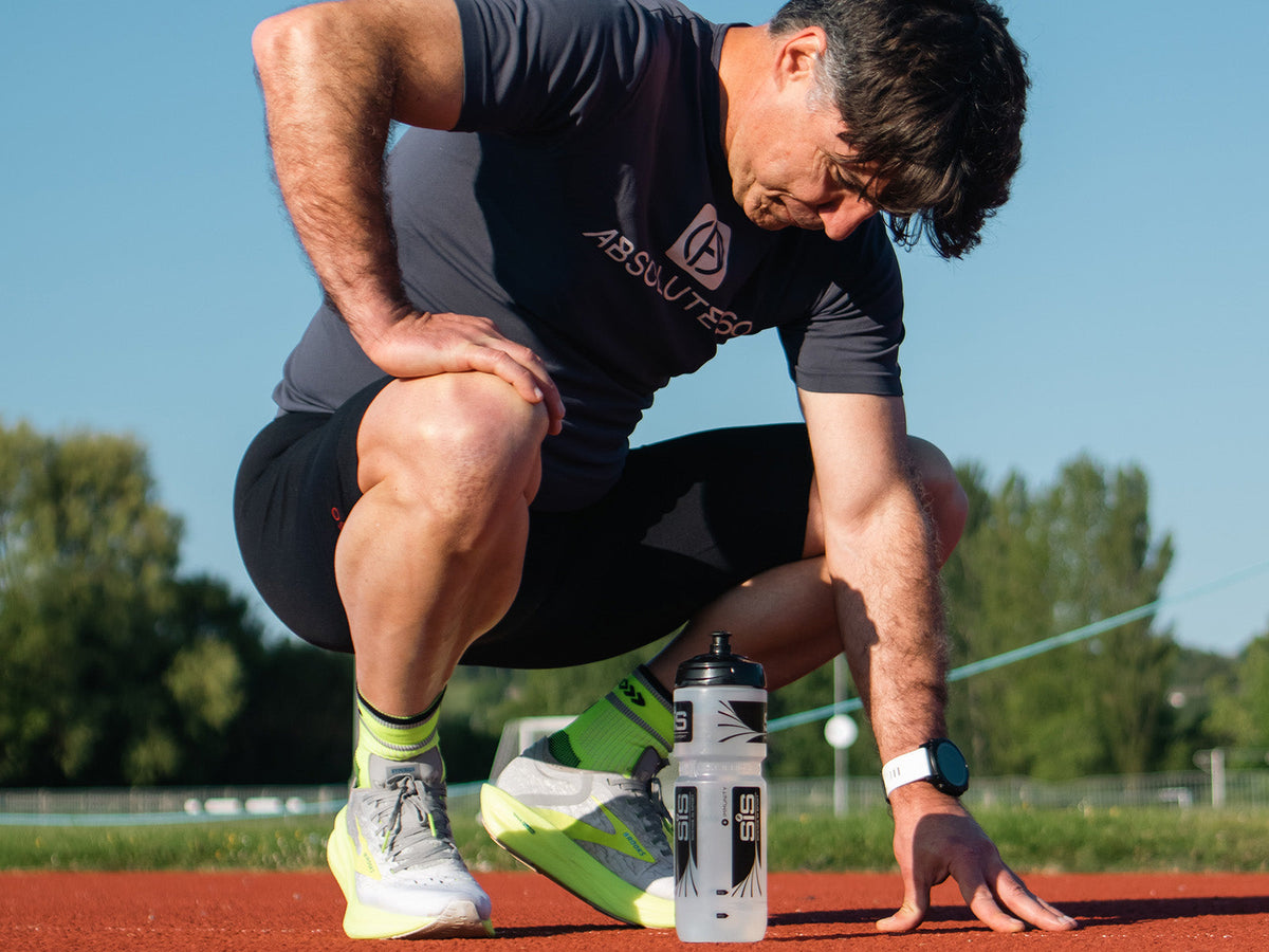 Runner recovering after a run with a water bottle