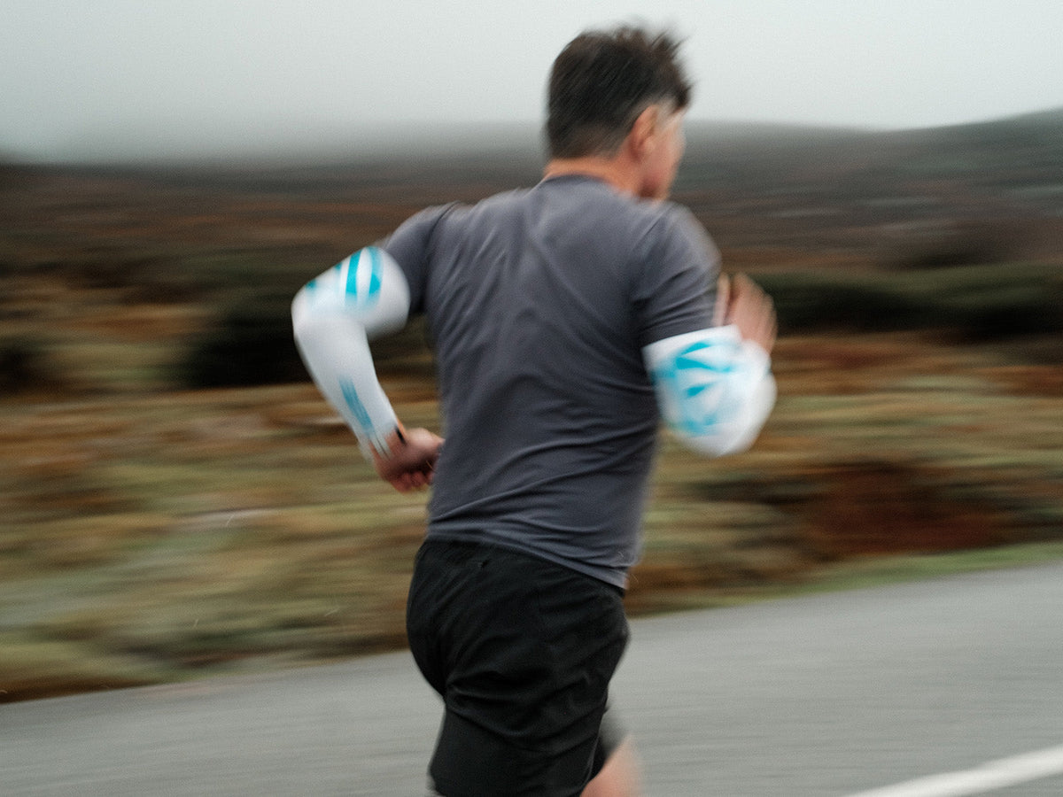 Runner wearing ABSOLUTE360 arm sleeves during an outdoor run