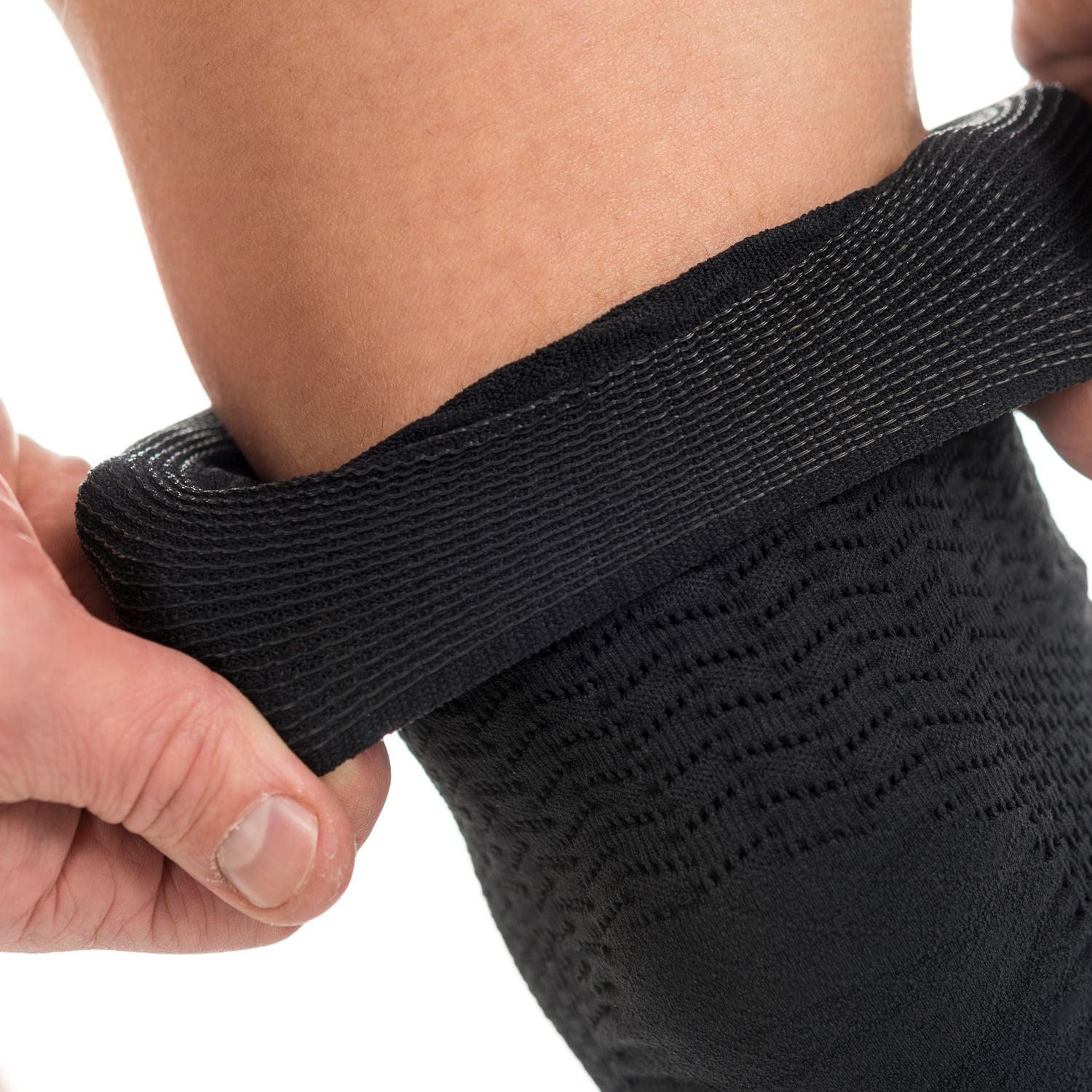 ABSOLUTE360 black knee support, featuring silicone grip yarn on white background